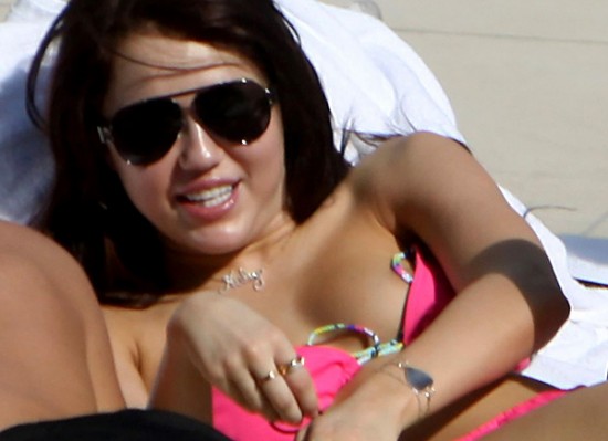 Miley Cyrus nipple slip Here is Miley Cyrus at her hotel pool in Miami 