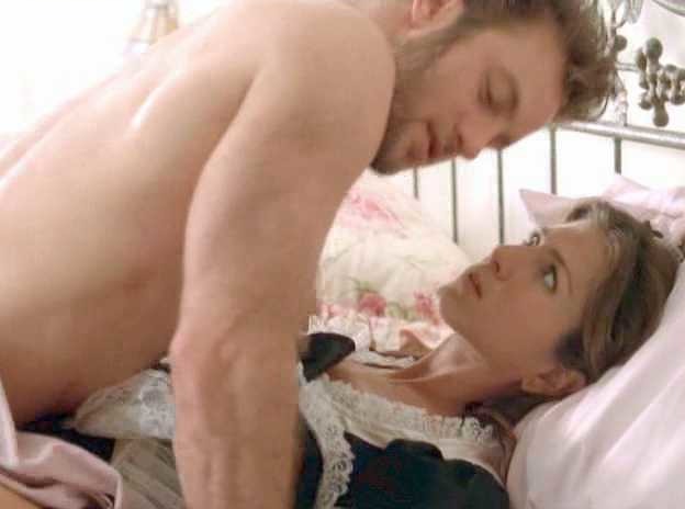 Jennifer Aniston in a maid outfit on the pillow with Scott Caan above her in Friends with Money (2006)