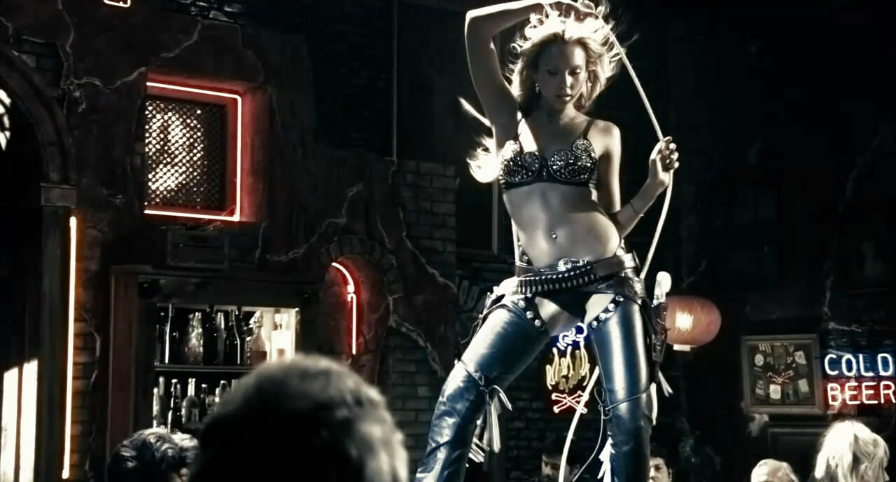Jessica Alba as Nancy Callahan dancing in a studded bra and chaps in Sin City (2005)