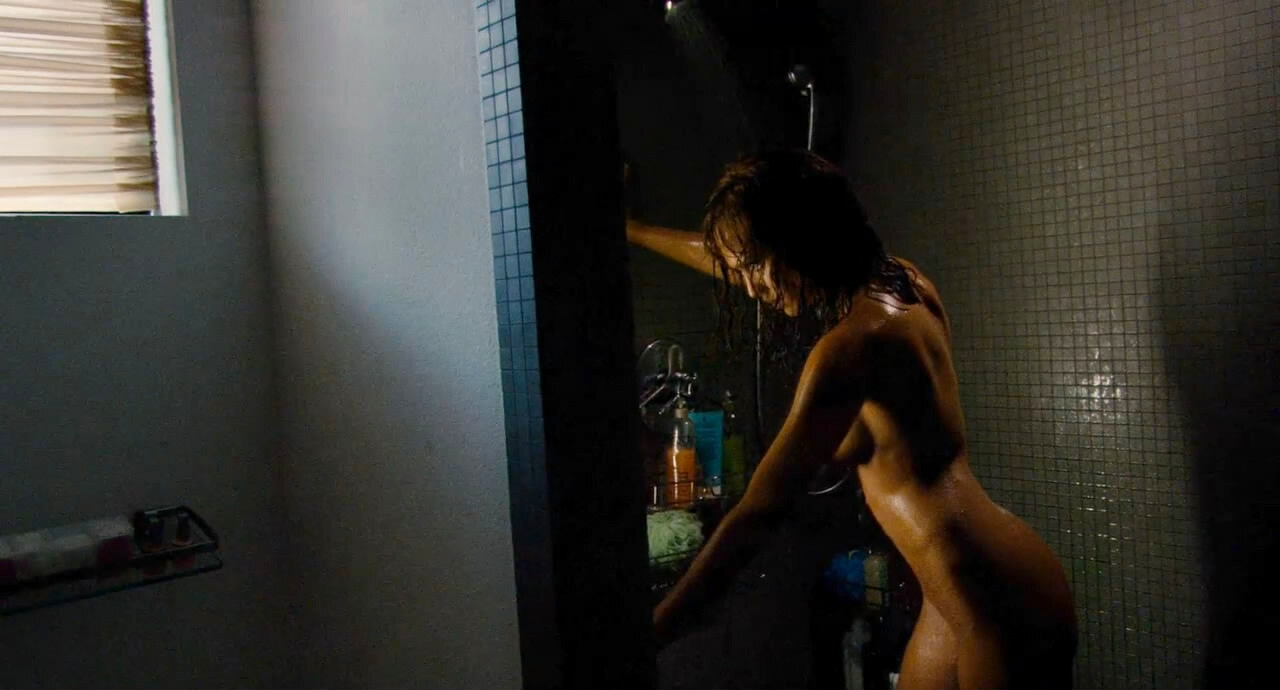 Jessica Alba nude in the Machete (2010) shower, reaching toward the caddy