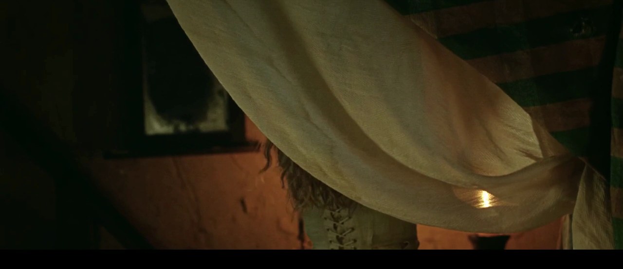 Amanda Seyfried as Ann Lee undressing for bed, The Testament of Ann Lee (2025)