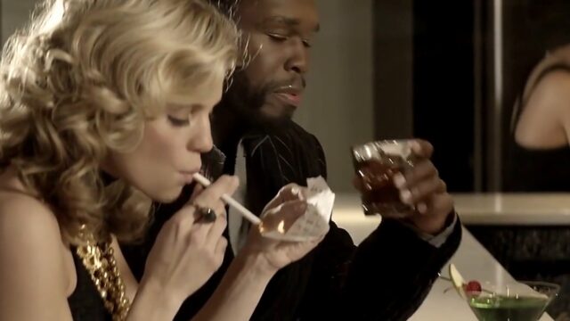 AnnaLynne McCord lighting a cigarette at a bar next to 50 Cent in Gun (2010)