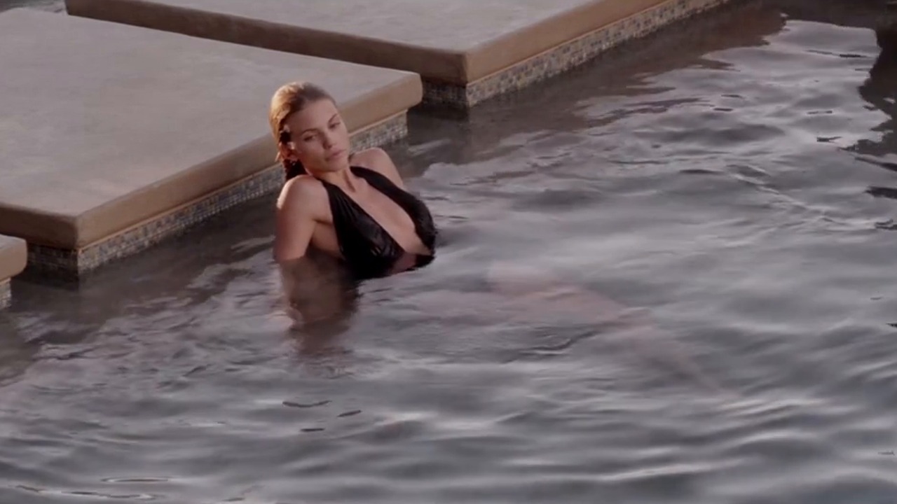 AnnaLynne McCord as May in a black swimsuit in the pool in Gutshot Straight (2014)