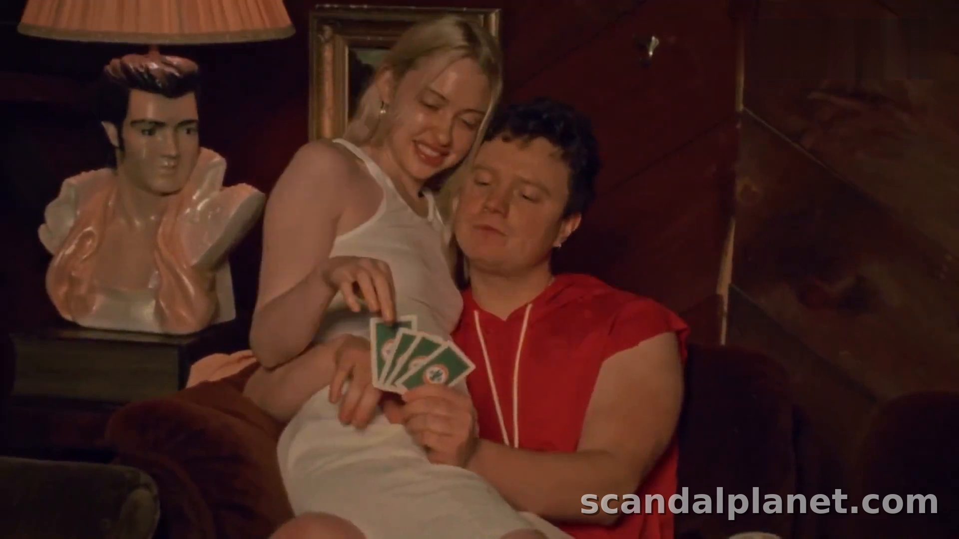 Chloe Cherry in a white tank top at the card game, Blood Barn (2025)