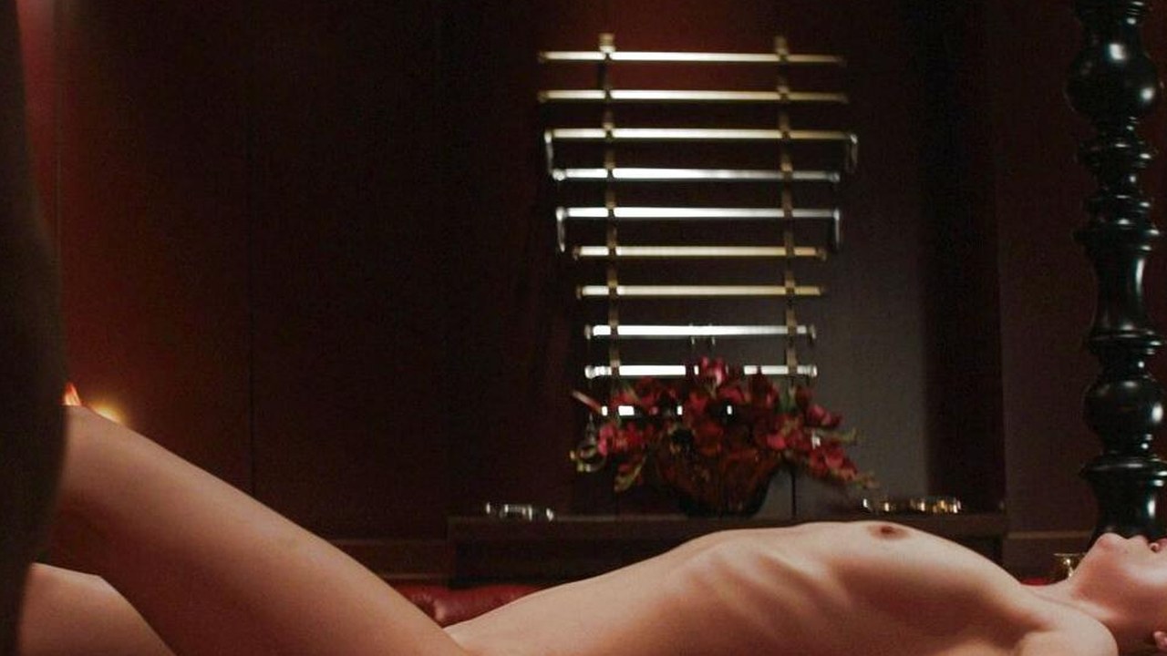 Dakota Johnson lying on the Red Room bed, Fifty Shades of Grey (2015)