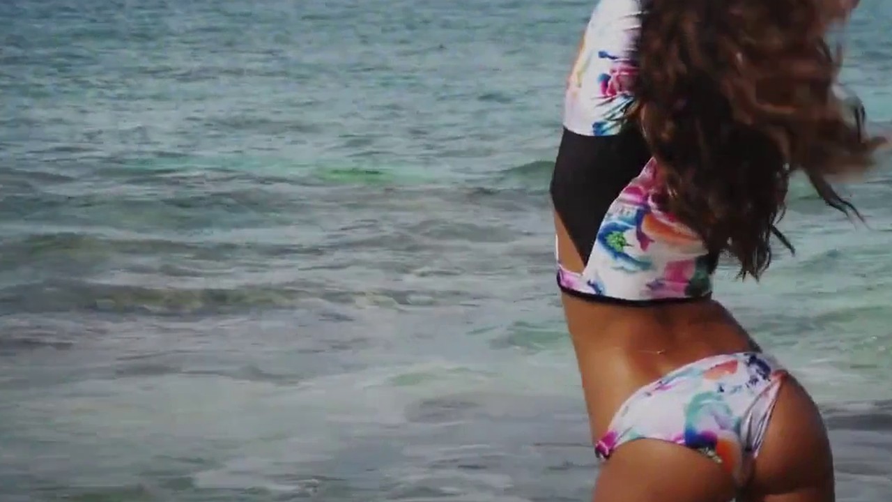 Irina Shayk in a floral bikini wading into the surf in the Sports Illustrated Swimsuit 2016 video