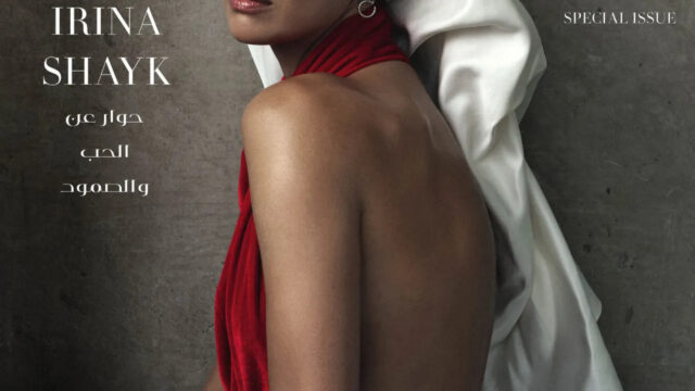 Irina Shayk full-length in black Prada jacket, waistcoat and wide trousers for Vogue Arabia October 2026