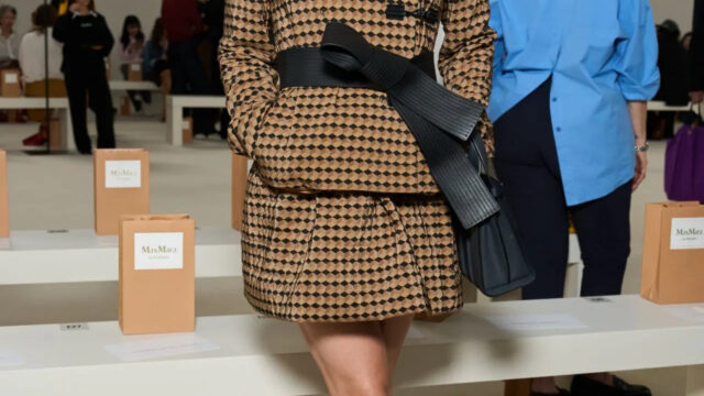 Kate Mara full-length in a tan-and-black Max Mara jacket, mini skirt and oversized black bow belt at the Max Mara show, Milan Fashion Week, September 2026