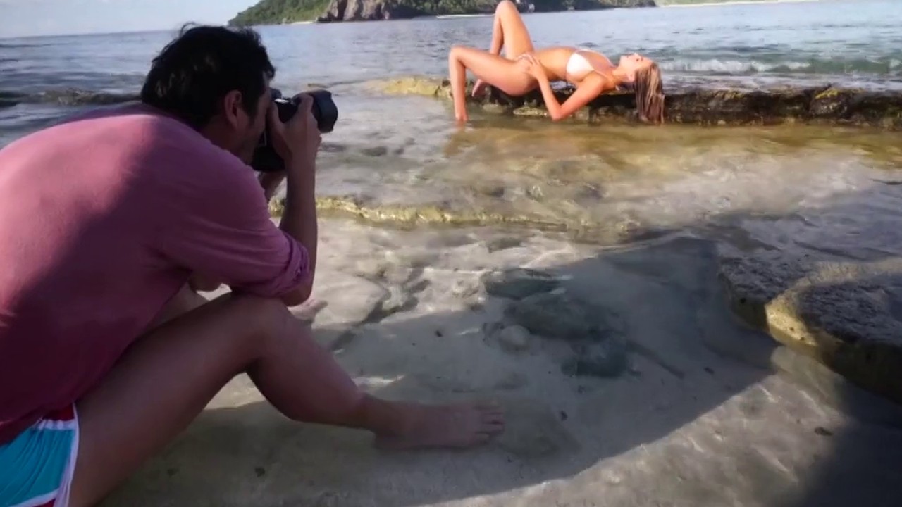 A photographer shooting Kate Upton on the rocks for Sports Illustrated Swimsuit 2017