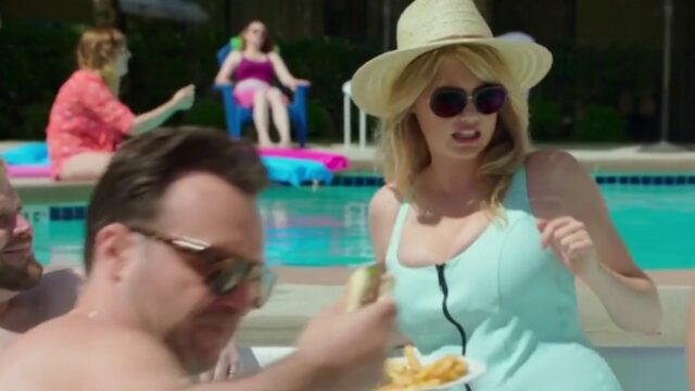 Kate Upton as Meg in a sun hat and mint swimsuit at the motel pool, The Layover (2017)