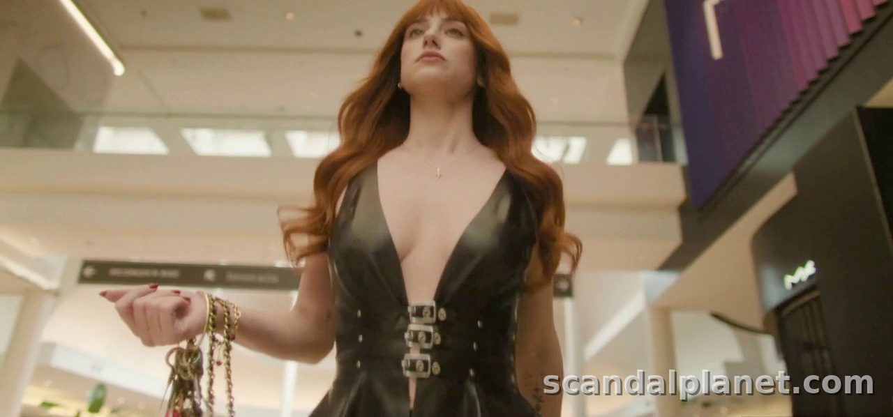 Lili Reinhart as Apple in a plunging black leather dress, Forbidden Fruits (2026)