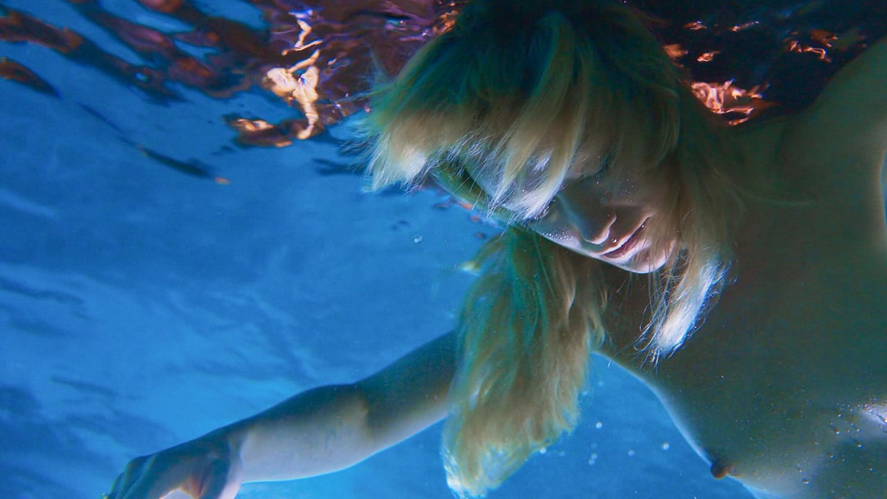 Olivia Wilde floating in the pool, I Want Your Sex (2026)