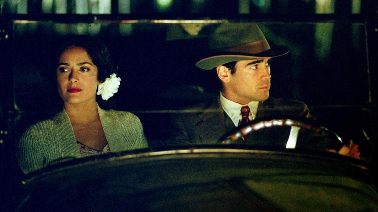 Salma Hayek as Camilla Lopez, a white flower in her hair, in a car at night with Colin Farrell in Ask the Dust (2006)