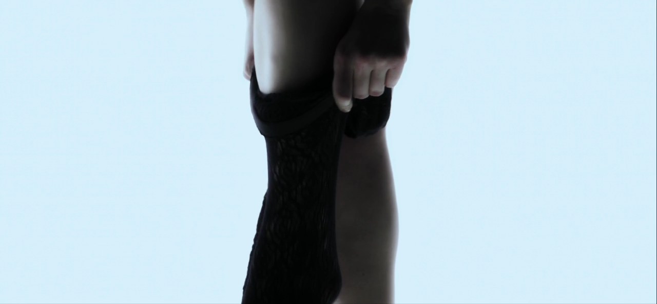 Scarlett Johansson pulling on a top in the opening, Under the Skin