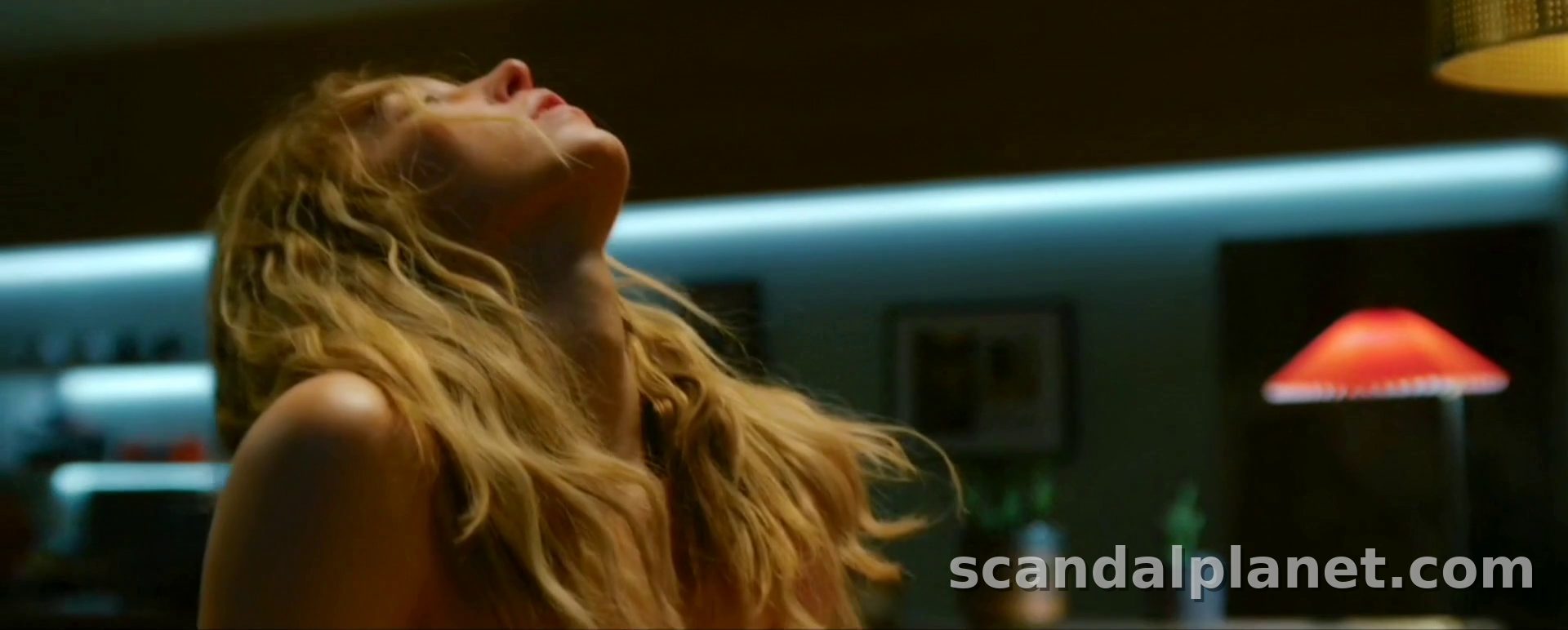 Sydney Sweeney with her head back under a red lamp, The Voyeurs