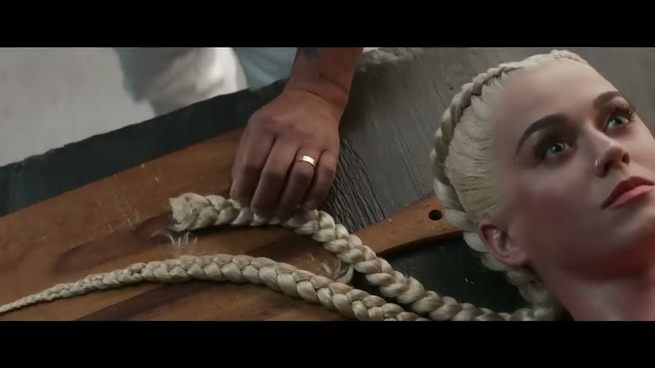 Katy Perry lying on the table with a braid of dough around her in the Bon Appetit video (2017)