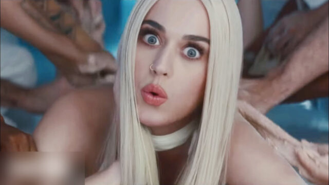 Katy Perry with platinum hair on the kitchen table, chefs' hands on her, in the Bon Appetit video (2017)