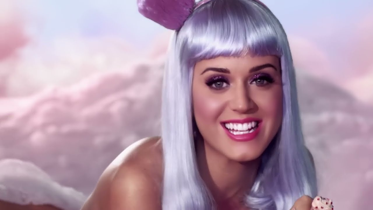 Katy Perry smiling in a lilac bob wig on the cotton-candy cloud, California Gurls (2010)