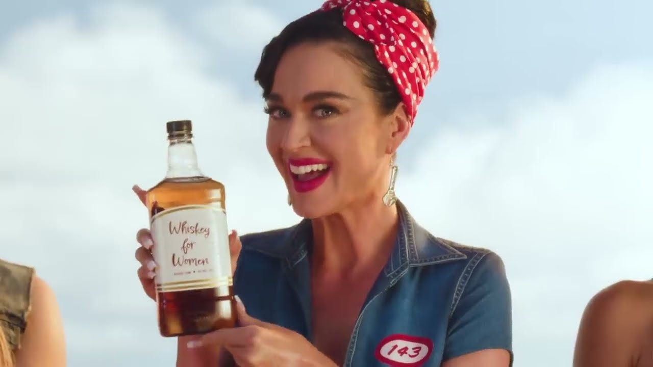 Katy Perry as a Rosie the Riveter worker with a red polka-dot bandana in the Woman's World video (2024)